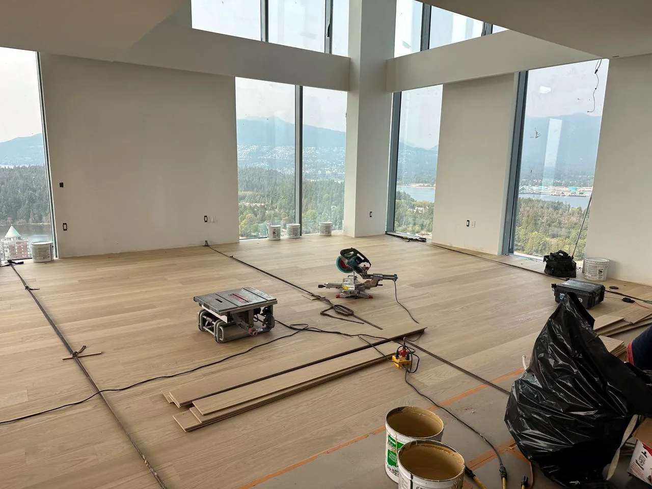 Large flooring installation in progress with tools and open interior space